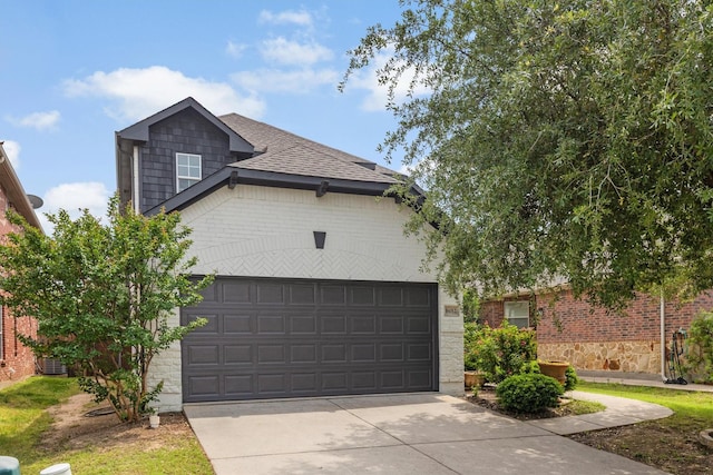 16012 Alvarado Dr, Prosper, TX 75078 - view of front of house featuring concrete driveway, an attached garage, a shingled roof, and brick siding