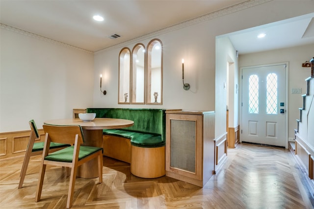 4306 Buena Vista St Unit 106F, Dallas, TX 75205 - dining room featuring breakfast area, recessed lighting, a wainscoted wall, and ornamental molding