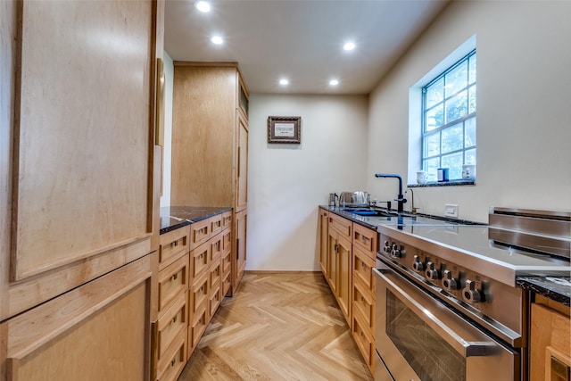 4306 Buena Vista St Unit 106F, Dallas, TX 75205 - kitchen featuring electric range, a sink, recessed lighting, dark stone counters, and light brown cabinets