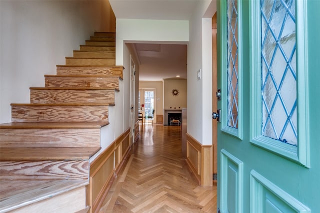 4306 Buena Vista St Unit 106F, Dallas, TX 75205 - foyer with a wainscoted wall, stairway, and a decorative wall