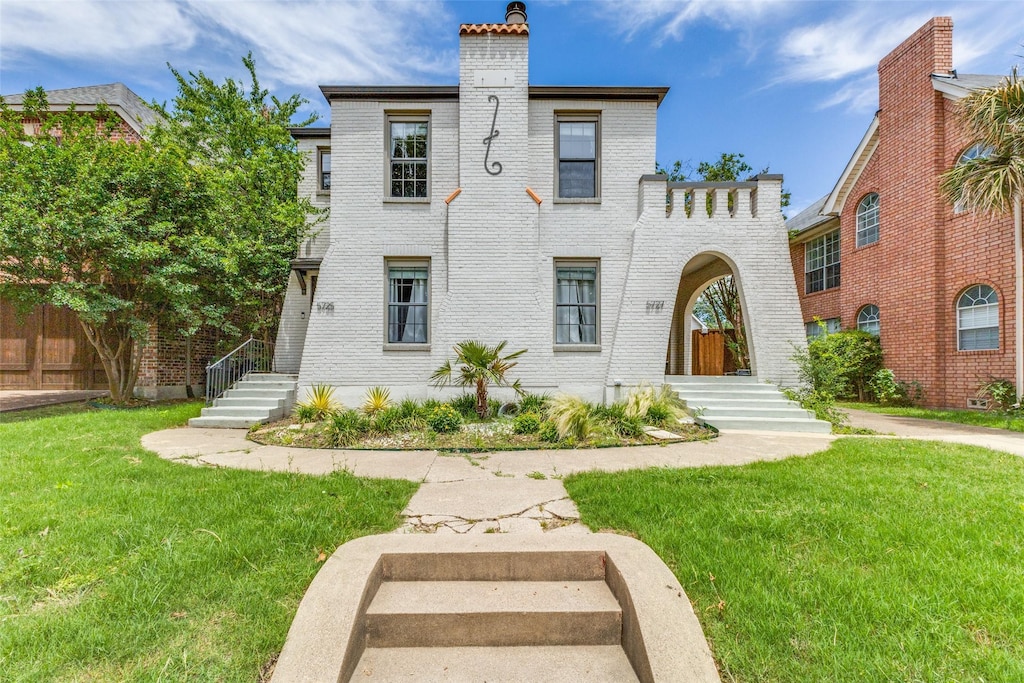 5725 Goodwin Ave, Dallas, TX 75206 - view of front of property with brick siding, a chimney, and a front lawn