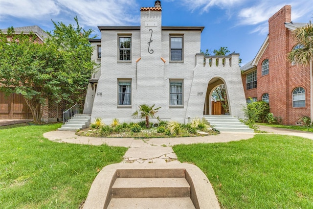 5725 Goodwin Ave, Dallas, TX 75206 - view of front of property with brick siding, a chimney, and a front lawn