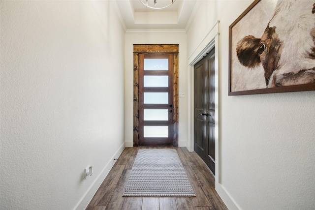 1308 Green Ridge Rd, Weatherford, TX 76085 - doorway to outside featuring healthy amount of natural light, dark wood-style flooring, baseboards, crown molding, and a textured wall