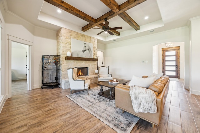 1308 Green Ridge Rd, Weatherford, TX 76085 - living room featuring a stone fireplace, coffered ceiling, wood finished floors, beam ceiling, and baseboards