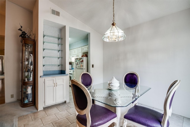 1916 Cobblestone Ln, Garland, TX 75042 - dining area featuring a chandelier, vaulted ceiling, and light tile patterned flooring