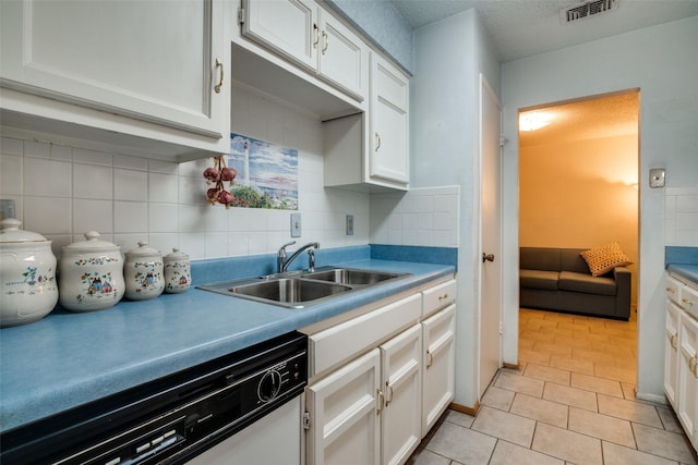 1916 Cobblestone Ln, Garland, TX 75042 - kitchen with dishwasher, a sink, decorative backsplash, light tile patterned flooring, and white cabinets