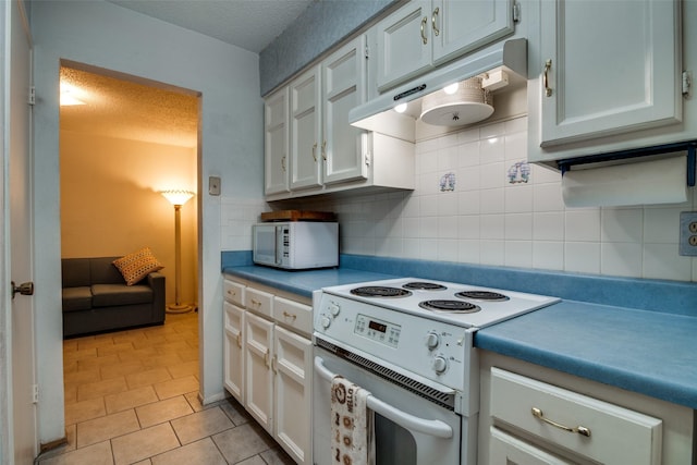 1916 Cobblestone Ln, Garland, TX 75042 - kitchen featuring white appliances, under cabinet range hood, decorative backsplash, light tile patterned floors, and a textured ceiling