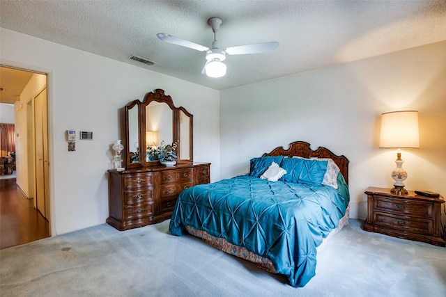 1916 Cobblestone Ln, Garland, TX 75042 - carpeted bedroom featuring a ceiling fan and a textured ceiling
