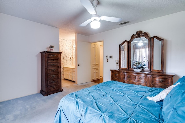 1916 Cobblestone Ln, Garland, TX 75042 - bedroom with light carpet, a ceiling fan, a textured ceiling, and connected bathroom