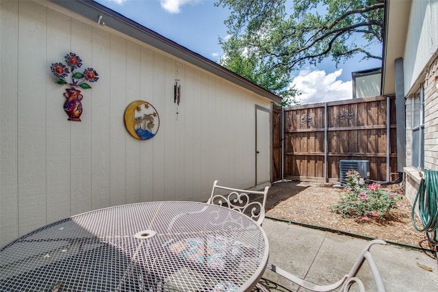 1916 Cobblestone Ln, Garland, TX 75042 - view of patio featuring central air condition unit and outdoor dining area