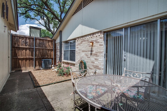 1916 Cobblestone Ln, Garland, TX 75042 - view of patio featuring outdoor dining area and central air condition unit