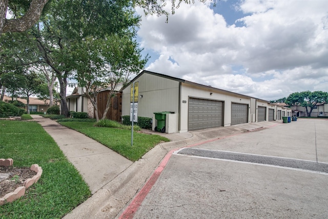 1916 Cobblestone Ln, Garland, TX 75042 - view of side of property with community garages and a yard