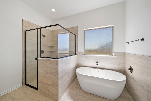 411 Solo Ridge Dr, Waxahachie, TX 75167 - full bathroom featuring tiled shower, a soaking tub, and tile walls