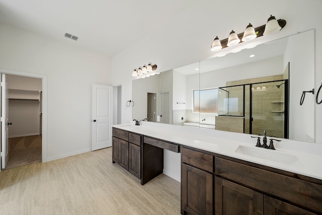 411 Solo Ridge Dr, Waxahachie, TX 75167 - full bath featuring wood finished floors, a stall shower, and double vanity