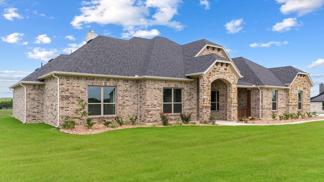 411 Solo Ridge Dr, Waxahachie, TX 75167 - french country style house featuring brick siding, a front lawn, and a shingled roof