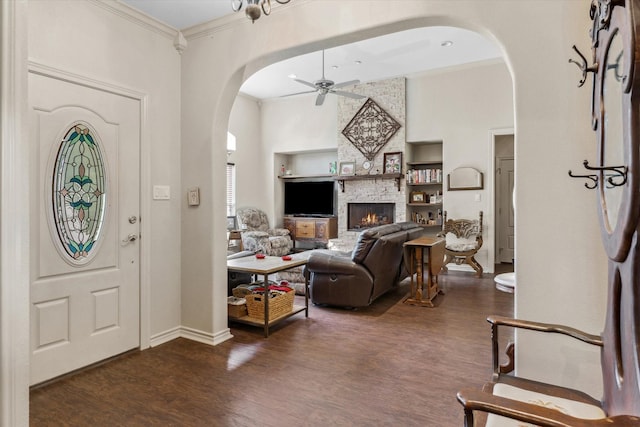 10040 Fm 17, Grand Saline, TX 75140 - entrance foyer with arched walkways, ceiling fan, dark wood-style floors, a fireplace, and ornamental molding