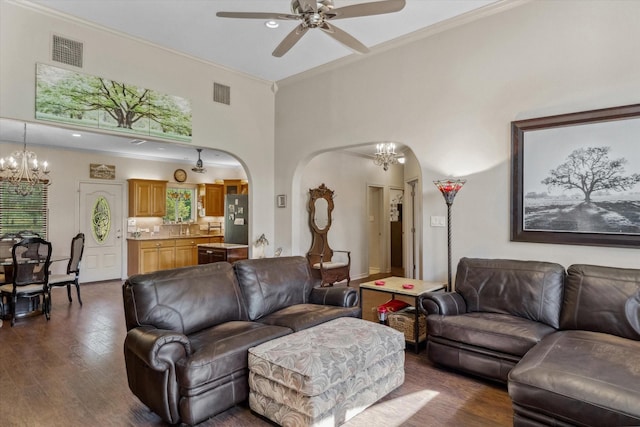 10040 Fm 17, Grand Saline, TX 75140 - living room featuring arched walkways, a chandelier, a ceiling fan, dark wood-style flooring, and crown molding