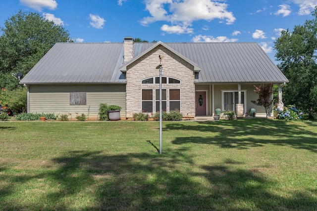 10040 Fm 17, Grand Saline, TX 75140 - view of front facade with a chimney, a front lawn, covered porch, and metal roof
