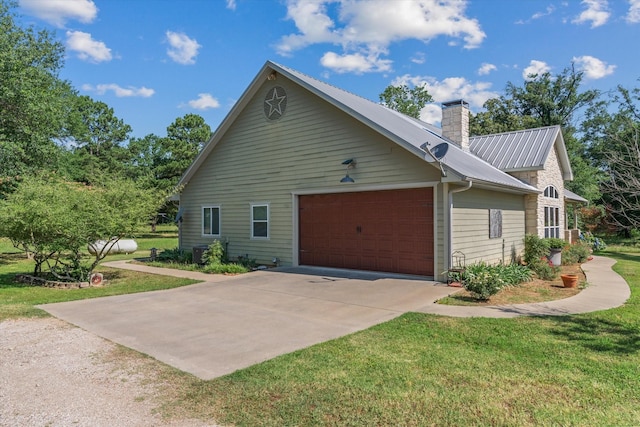 10040 Fm 17, Grand Saline, TX 75140 - view of home's exterior with a garage, a chimney, driveway, metal roof, and a lawn
