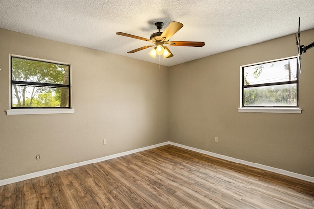 1023 Holmes Dr, Granbury, TX 76048 - unfurnished room featuring wood finished floors, ceiling fan, baseboards, and a textured ceiling