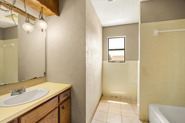 1023 Holmes Dr, Granbury, TX 76048 - full bath featuring vanity, tile patterned flooring, a bath, a shower, and a textured ceiling