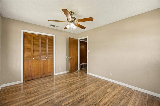 1023 Holmes Dr, Granbury, TX 76048 - unfurnished bedroom featuring wood finished floors, baseboards, a closet, and a ceiling fan