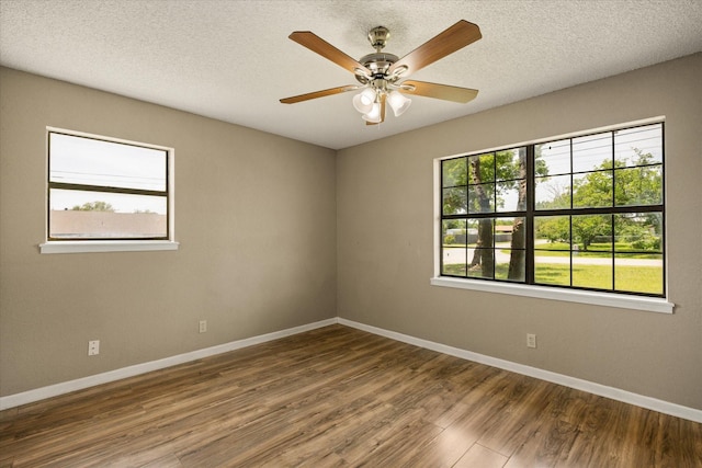 1023 Holmes Dr, Granbury, TX 76048 - empty room featuring baseboards, wood finished floors, ceiling fan, and a textured ceiling