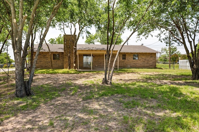 1023 Holmes Dr, Granbury, TX 76048 - rear view of property featuring brick siding