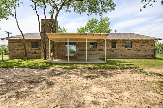 1023 Holmes Dr, Granbury, TX 76048 - back of house featuring a patio, brick siding, a lawn, and a chimney
