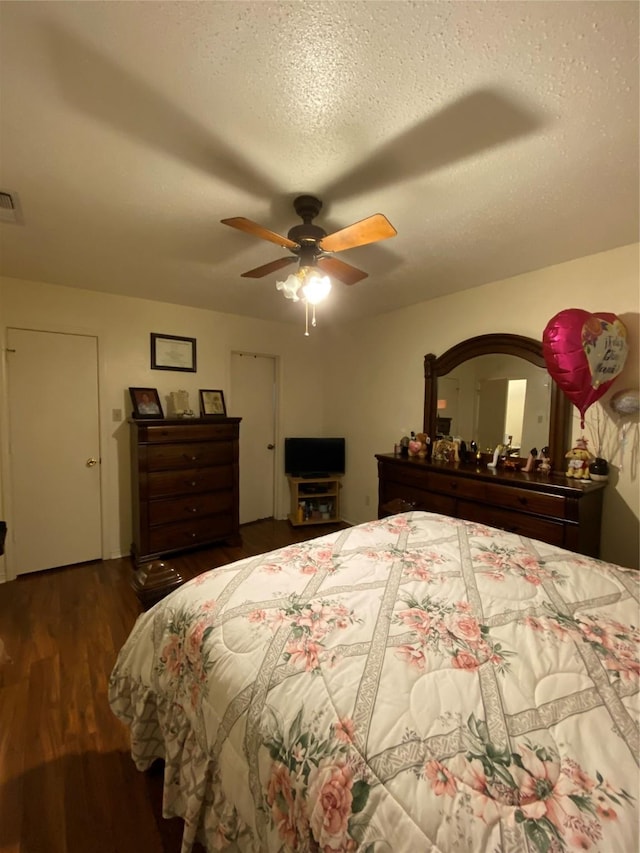 1203 Springbrook Cir, Desoto, TX 75115 - bedroom featuring wood finished floors, a ceiling fan, and a textured ceiling