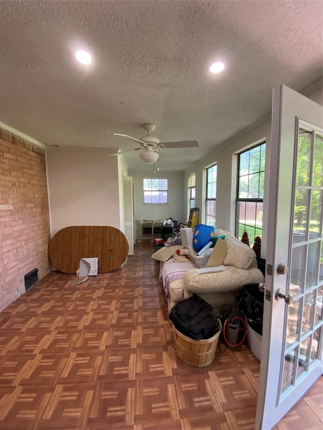 1203 Springbrook Cir, Desoto, TX 75115 - living room with a textured ceiling, a ceiling fan, brick wall, and recessed lighting