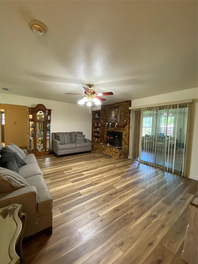 1203 Springbrook Cir, Desoto, TX 75115 - living area with wood finished floors, a ceiling fan, and plenty of natural light