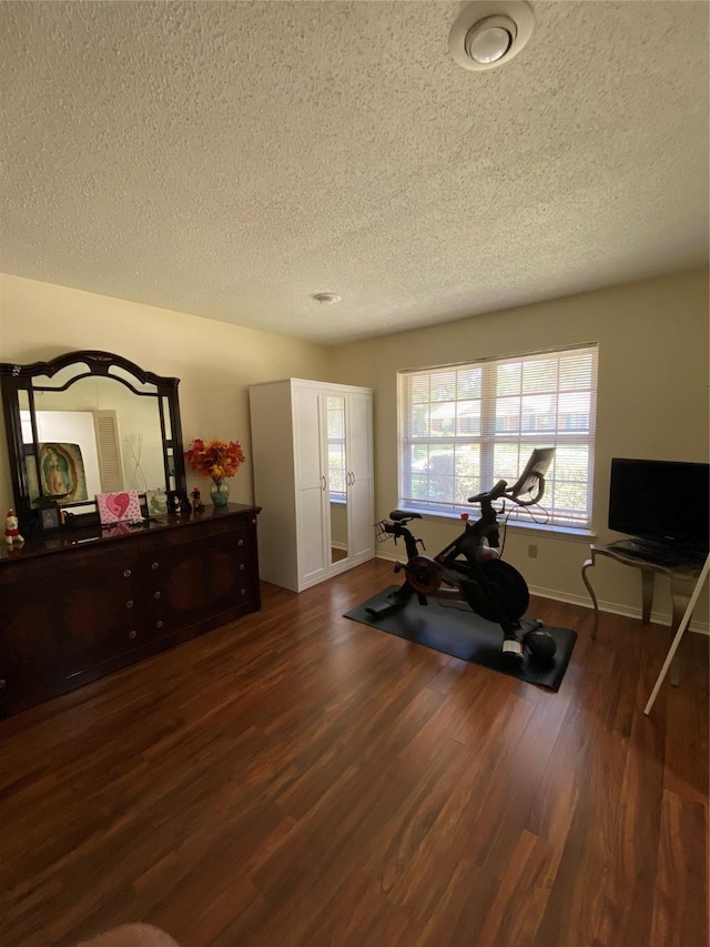 1203 Springbrook Cir, Desoto, TX 75115 - workout area with a textured ceiling, wood finished floors, and baseboards