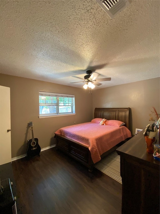 1203 Springbrook Cir, Desoto, TX 75115 - bedroom with dark wood finished floors, a textured ceiling, ceiling fan, and baseboards