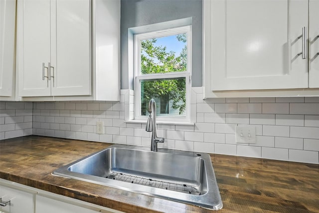 906 S Willow St, Sherman, TX 75090 - kitchen featuring wood counters, white cabinets, and tasteful backsplash