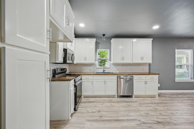 906 S Willow St, Sherman, TX 75090 - kitchen featuring appliances with stainless steel finishes, wooden counters, decorative backsplash, recessed lighting, and light wood-style floors