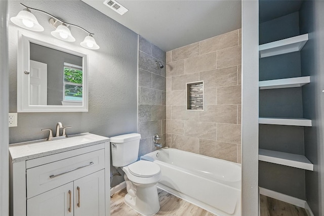 906 S Willow St, Sherman, TX 75090 - bathroom featuring wood finished floors, vanity, and shower / tub combination