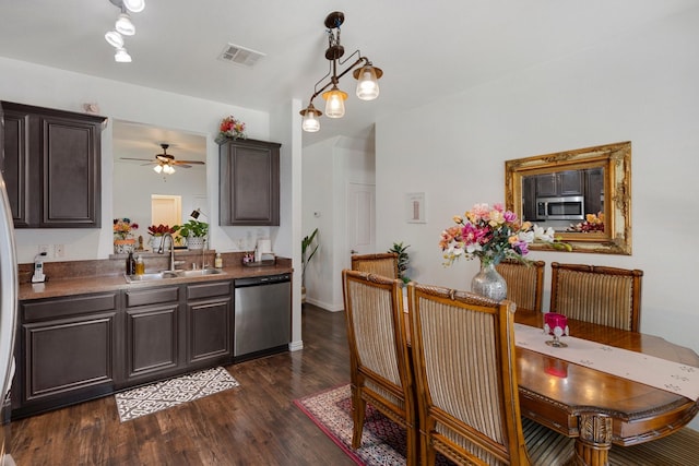 1213 Alder Tree Ln, Royse City, TX 75189 - kitchen featuring stainless steel appliances, a sink, dark brown cabinetry, dark wood-style floors, and a ceiling fan