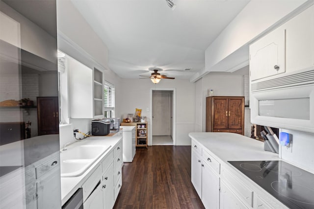 103 Auburn St, Waxahachie, TX 75165 - kitchen with black electric stovetop, a sink, white microwave, a ceiling fan, and white cabinetry