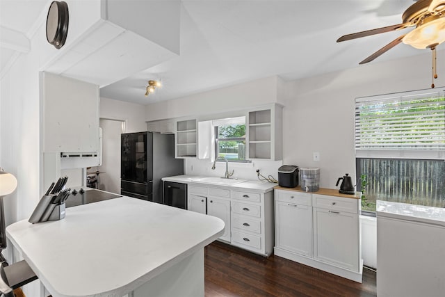 103 Auburn St, Waxahachie, TX 75165 - kitchen featuring a sink, dark wood-style floors, a ceiling fan, black appliances, and light countertops