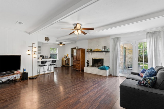 103 Auburn St, Waxahachie, TX 75165 - living area featuring ceiling fan, wood finished floors, beam ceiling, and a fireplace
