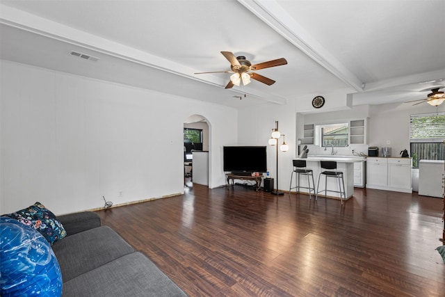 103 Auburn St, Waxahachie, TX 75165 - living room with a ceiling fan, wood finished floors, beamed ceiling, and arched walkways