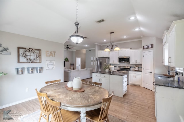 3009 Sterling St, Abilene, TX 79606 - dining area featuring lofted ceiling, light wood-style flooring, ceiling fan, crown molding, and baseboards