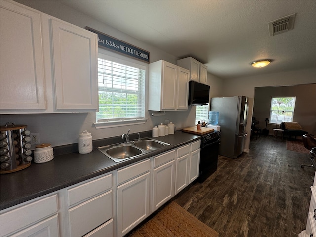 706 Jefferson Ave, Cisco, TX 76437 - kitchen with black appliances, a sink, dark countertops, and white cabinets