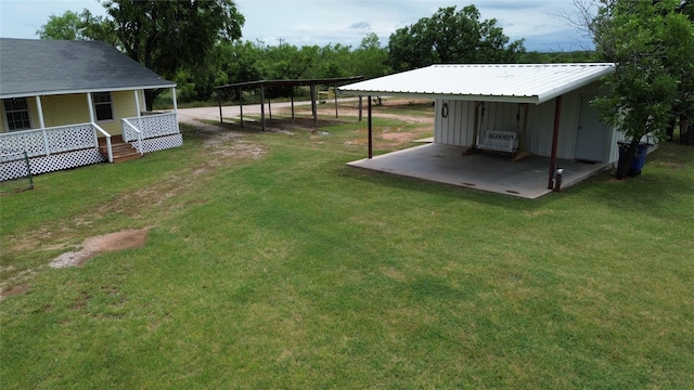 706 Jefferson Ave, Cisco, TX 76437 - view of green lawn featuring a carport and a porch
