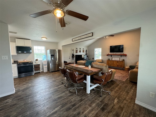 706 Jefferson Ave, Cisco, TX 76437 - dining area featuring plenty of natural light, dark wood-style flooring, ceiling fan, and baseboards
