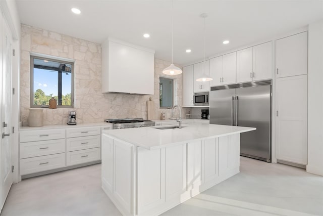 23538 Kate Ln, Arp, TX 75750 - kitchen featuring built in appliances, a sink, decorative backsplash, a center island with sink, and white cabinetry