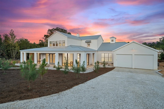 23538 Kate Ln, Arp, TX 75750 - modern farmhouse style home featuring concrete driveway, covered porch, an attached garage, metal roof, and stucco siding