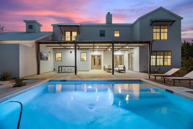 23538 Kate Ln, Arp, TX 75750 - back of property at dusk with french doors, stucco siding, a chimney, and a patio area