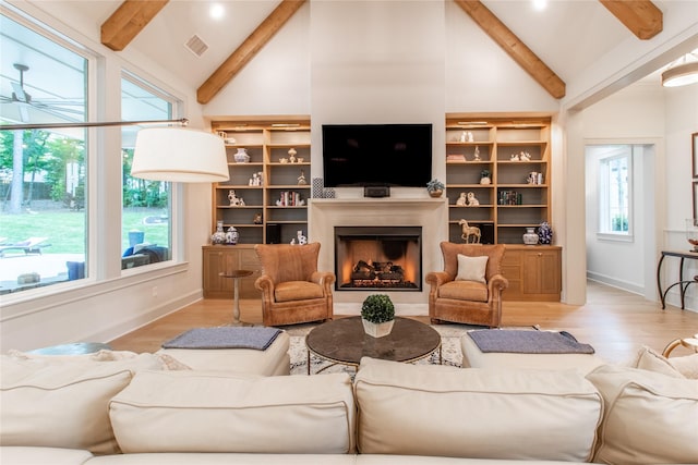 5620 Copper Park, Tyler, TX 75703 - living room featuring beamed ceiling, wood finished floors, a fireplace, high vaulted ceiling, and baseboards